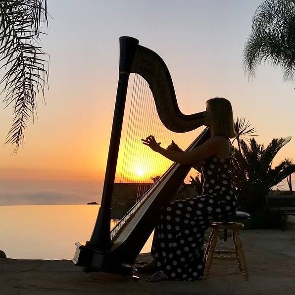 Harpist playing at sunset